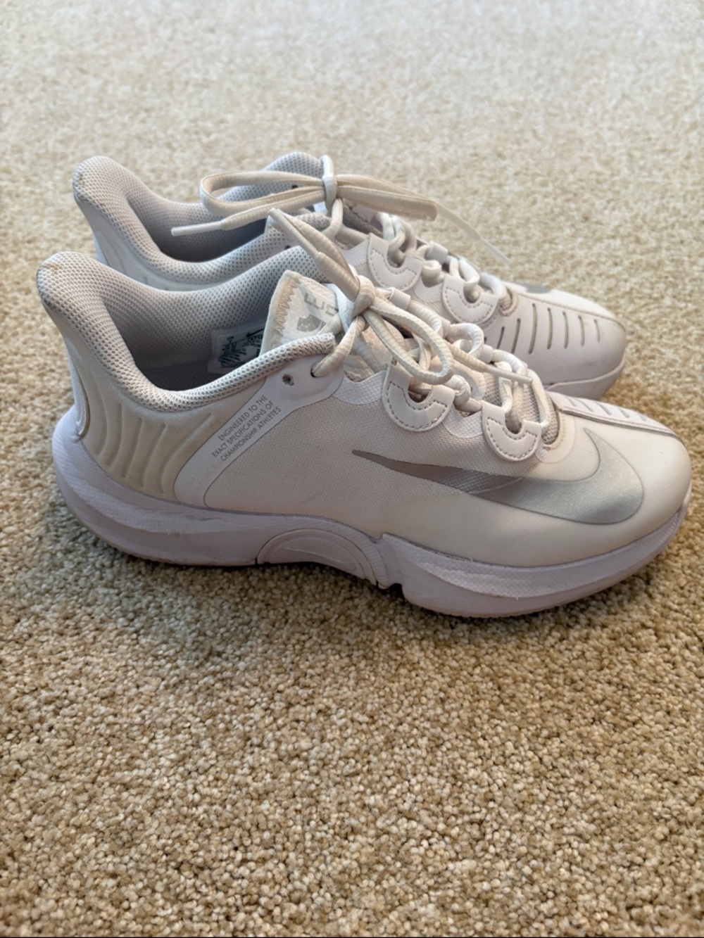 Women’s Nike Zoom white and silver tennis shoes